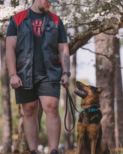 Zack Barkley walking a German Shepherd